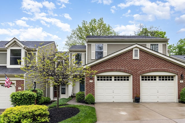 view of front of property with a garage, driveway, and brick siding