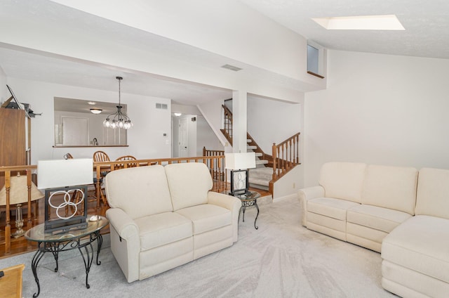 carpeted living room featuring stairs, visible vents, and lofted ceiling