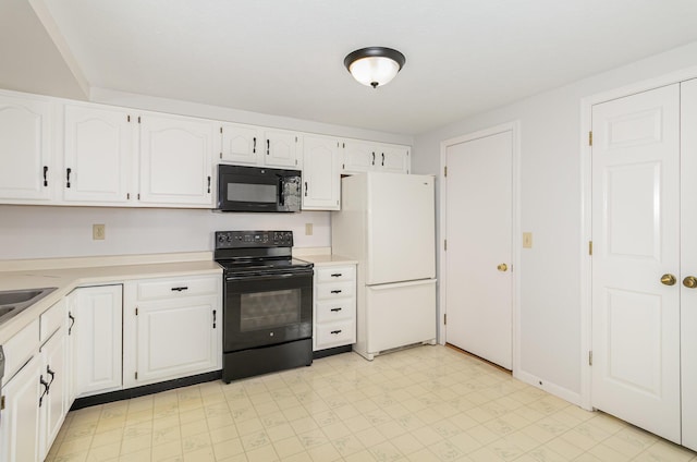 kitchen featuring white cabinets, light countertops, black appliances, and light floors