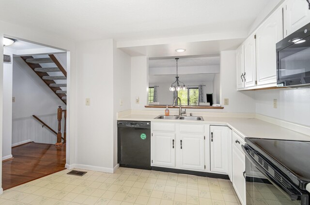 kitchen with light floors, light countertops, white cabinetry, a sink, and black appliances