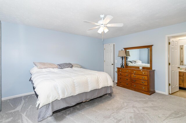 bedroom featuring a ceiling fan, baseboards, and light colored carpet