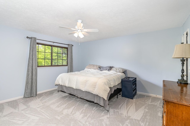 bedroom with carpet floors, a ceiling fan, and baseboards