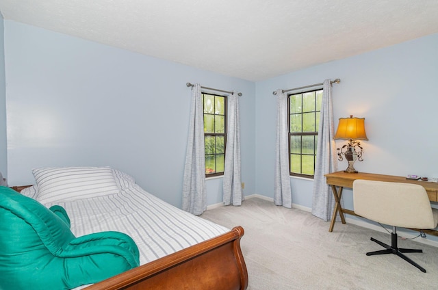 carpeted bedroom with baseboards