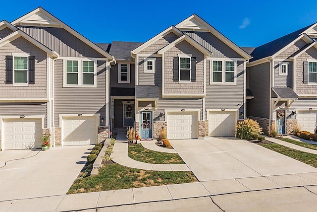 view of front facade featuring an attached garage, board and batten siding, and driveway