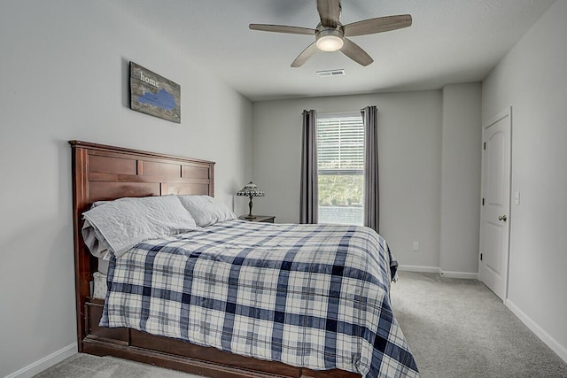 carpeted bedroom with a ceiling fan, baseboards, and visible vents