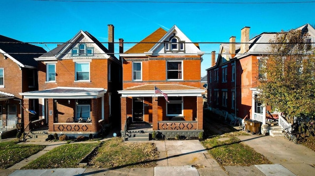 view of front facade featuring covered porch and brick siding