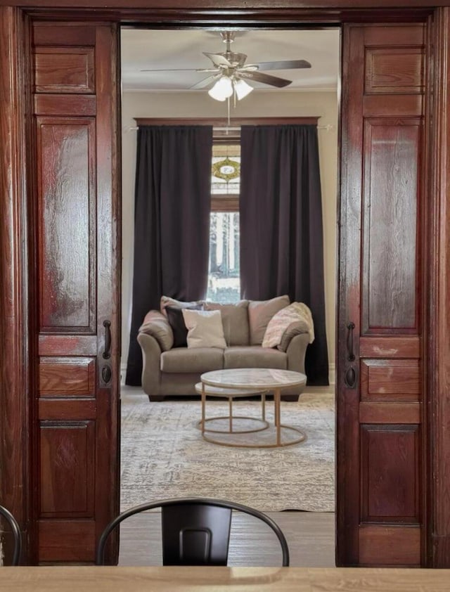 living area featuring ceiling fan and wood finished floors