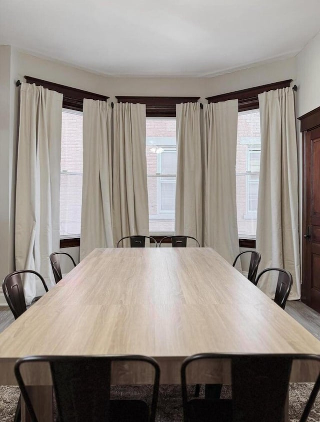 dining area featuring plenty of natural light and wood finished floors