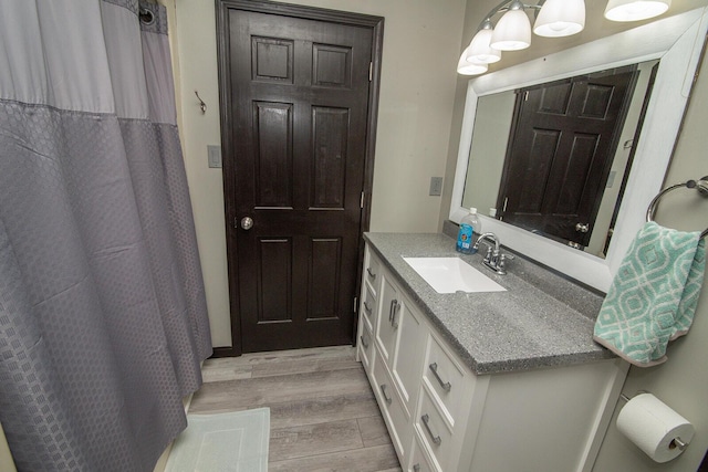 full bath featuring vanity and wood finished floors