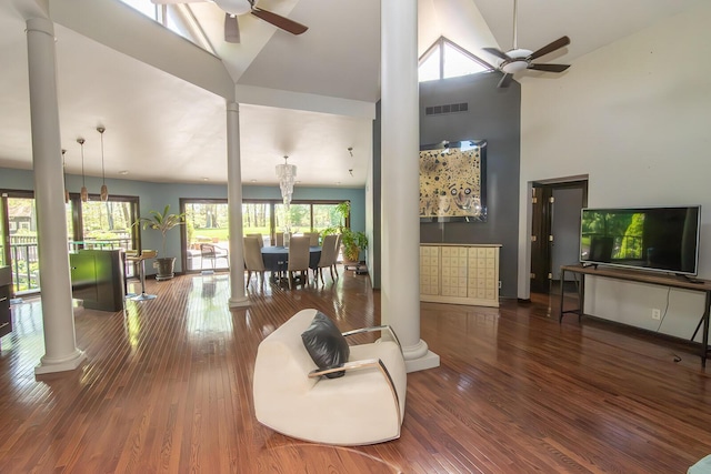living room featuring high vaulted ceiling, ceiling fan, decorative columns, and visible vents