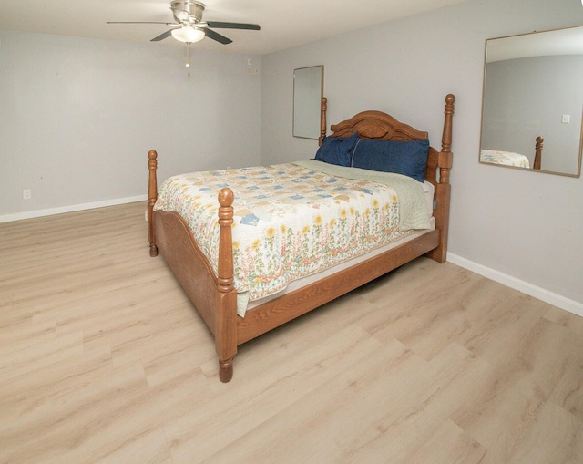 bedroom featuring baseboards, ceiling fan, and wood finished floors