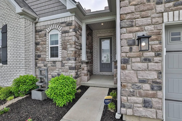 view of exterior entry with brick siding