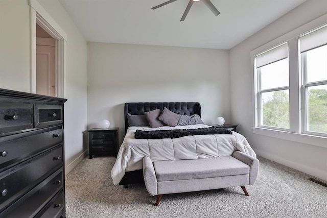bedroom with baseboards, carpet, a ceiling fan, and visible vents