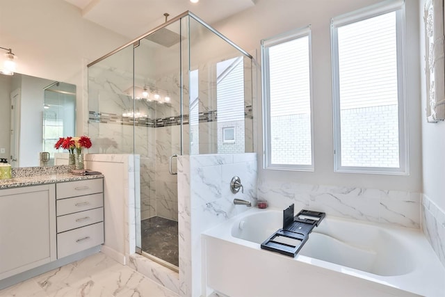 bathroom featuring a stall shower, marble finish floor, a garden tub, and vanity