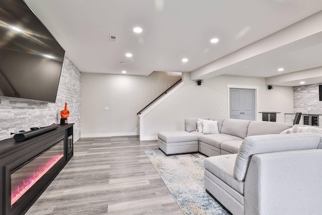 living area with visible vents, recessed lighting, light wood-style flooring, and stairway
