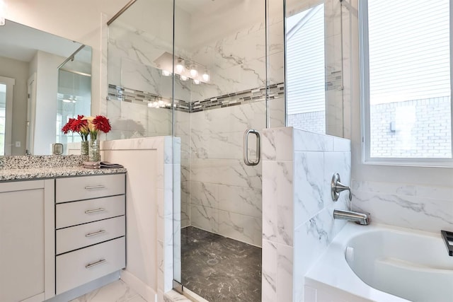 full bathroom featuring a bath, a shower stall, marble finish floor, and vanity