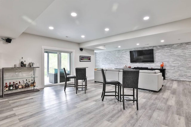 interior space featuring light wood-style floors, a dry bar, and recessed lighting