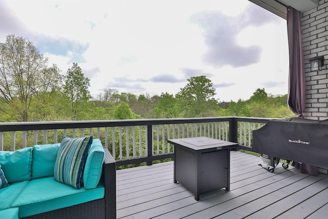 wooden deck with area for grilling and outdoor lounge area