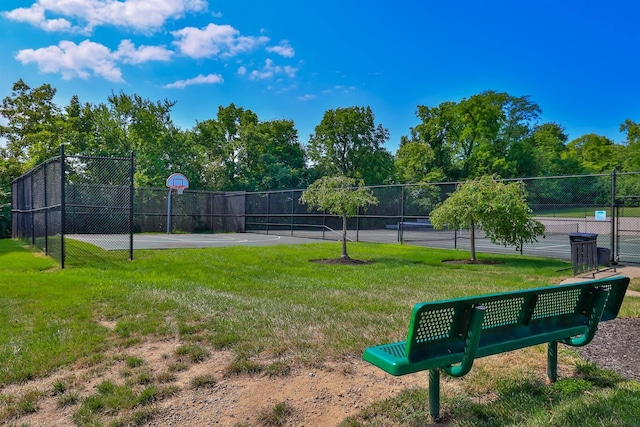view of home's community featuring a yard, community basketball court, fence, and a tennis court