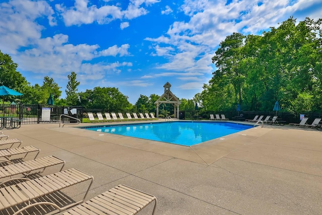 pool featuring a patio and fence