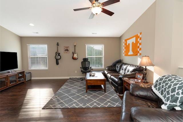 living area with a ceiling fan, baseboards, visible vents, and wood finished floors