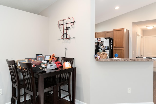 dining area featuring baseboards, lofted ceiling, and recessed lighting