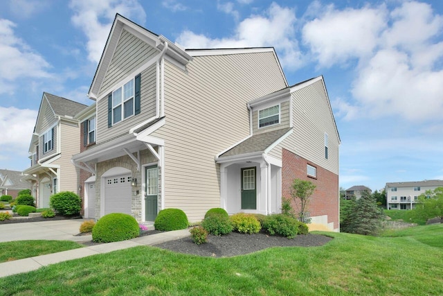 view of front of property with a garage, driveway, brick siding, and a front yard