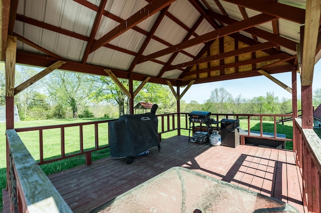 wooden terrace featuring a yard, a gazebo, and a grill