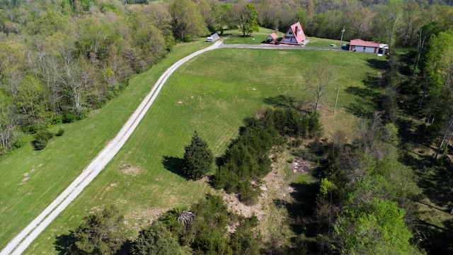 aerial view of sparsely populated area featuring a heavily wooded area