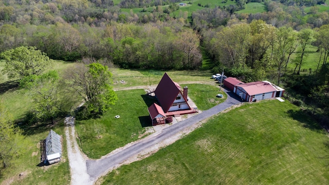 aerial view of property and surrounding area with a forest