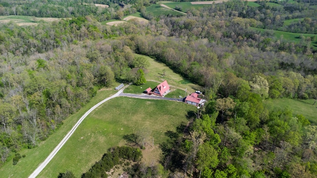 view of property location with a forest and rural landscape