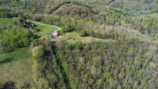 aerial view of property's location featuring a forest