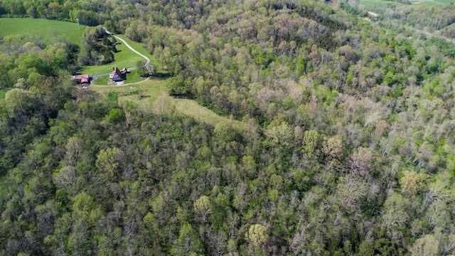 view of property location featuring a heavily wooded area