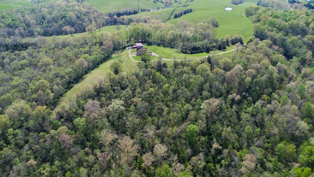 aerial view of property's location featuring a heavily wooded area