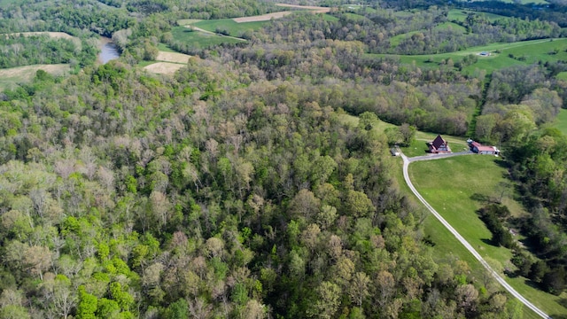 aerial overview of property's location with a heavily wooded area