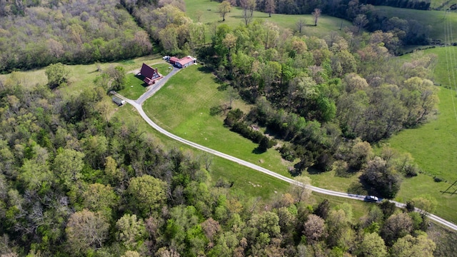 aerial overview of property's location with rural landscape and a heavily wooded area