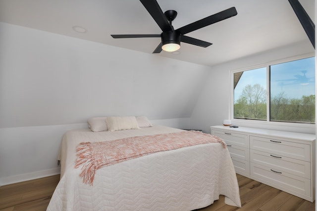 bedroom featuring light wood finished floors, baseboards, and ceiling fan
