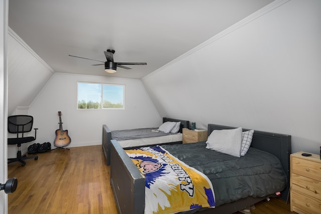 bedroom featuring wood finished floors, a ceiling fan, and vaulted ceiling