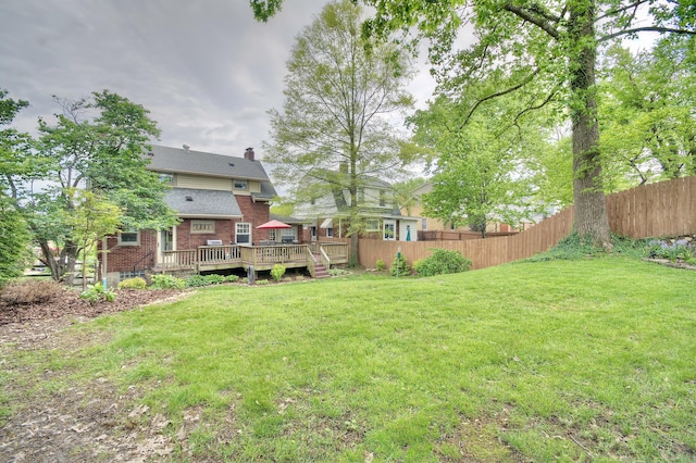 view of yard featuring fence and a deck