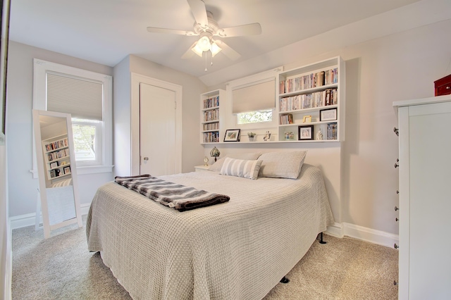 bedroom featuring a closet, baseboards, a ceiling fan, and carpet flooring