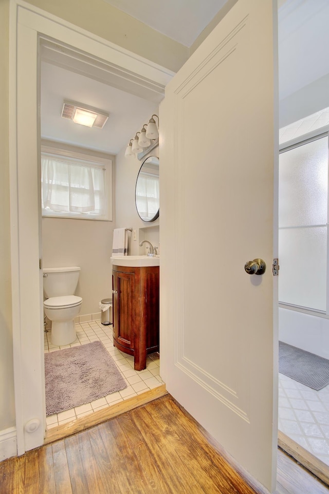 bathroom with vanity, tile patterned flooring, and toilet