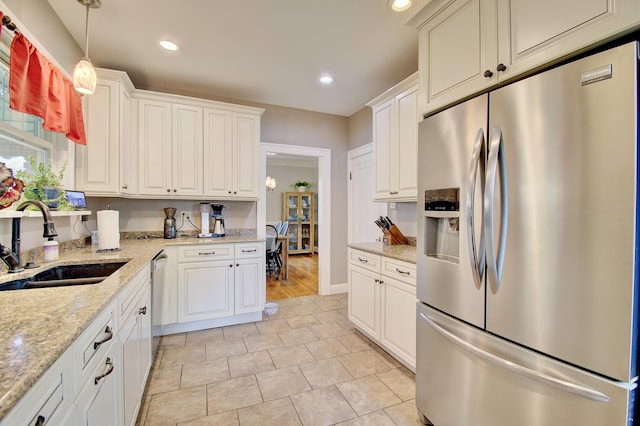 kitchen with recessed lighting, a sink, appliances with stainless steel finishes, and white cabinets