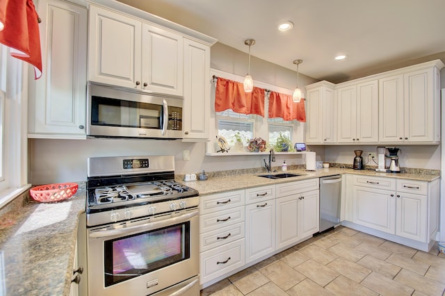 kitchen with pendant lighting, appliances with stainless steel finishes, a sink, recessed lighting, and white cabinetry