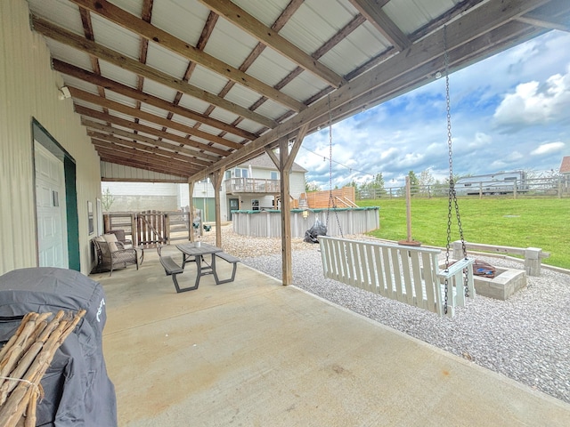 view of patio / terrace featuring fence and an outdoor pool