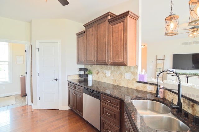 kitchen with a sink, dishwasher, a ceiling fan, decorative backsplash, and dark wood-type flooring