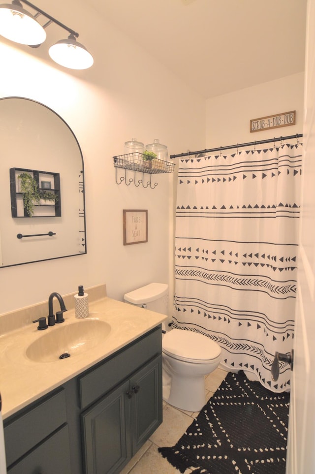 bathroom featuring vanity, toilet, tile patterned floors, and curtained shower