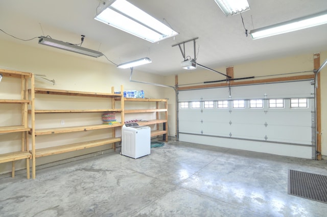 garage featuring visible vents and a garage door opener