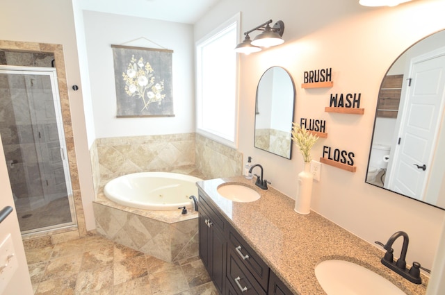 full bath featuring a sink, a stall shower, and a healthy amount of sunlight
