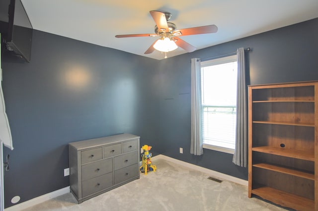 unfurnished bedroom featuring visible vents, baseboards, carpet floors, and multiple windows