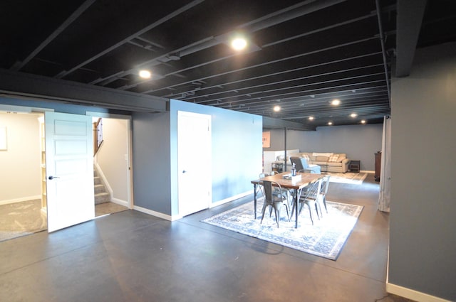 finished basement featuring stairs and baseboards